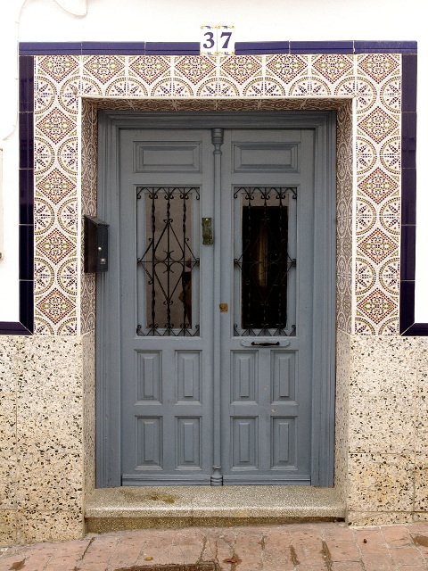 Blue door with tiles in Carratraca, Málaga